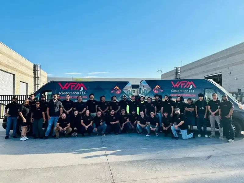 The WFM Restoration team standing in front of their service vans